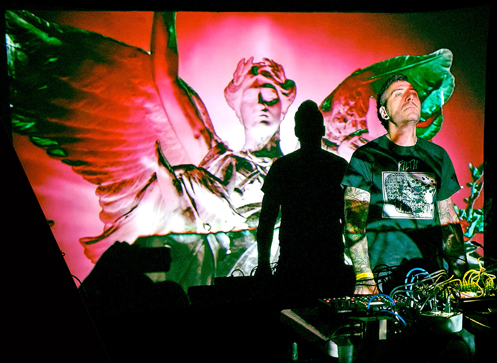 Egan Budd performing live with projected visuals